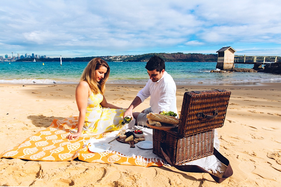 Couple enjoying a romantic picnic at Camp Cove, Watsons Bay in Sydney's eastern suburbs.