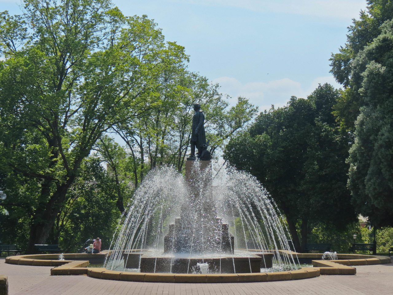 a statue of Governor Sir John Franklin on a water fountain, with water spurting out.