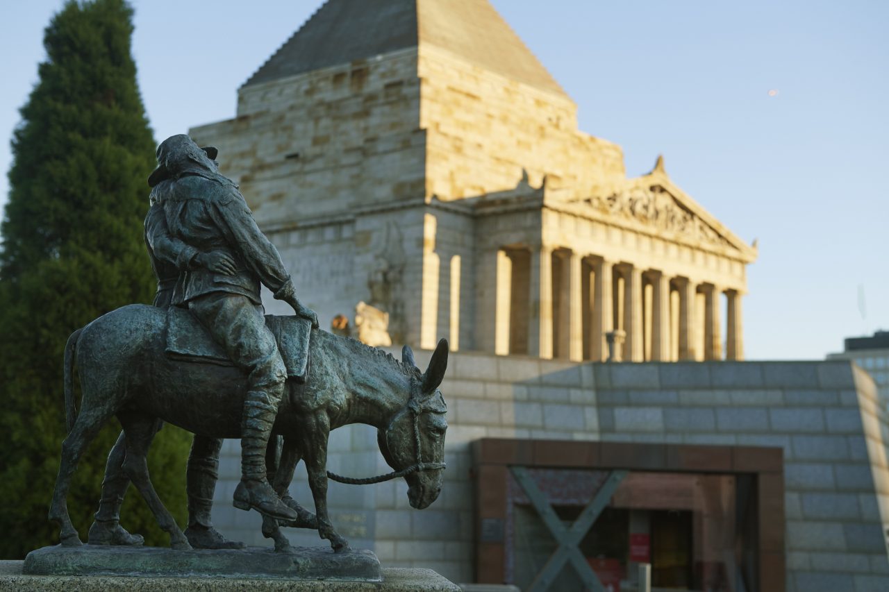 Shrine of Remembrance in the background with a statute of soldiers on a donkey.