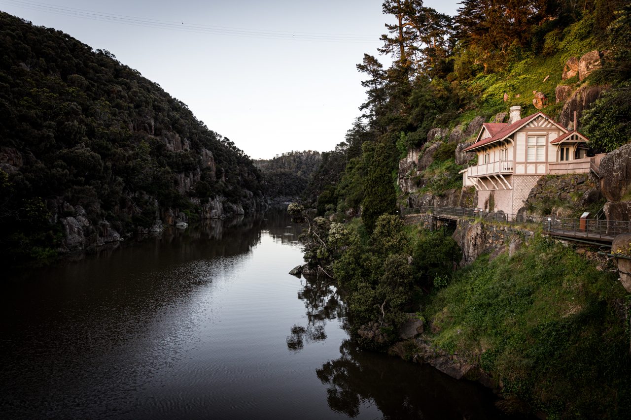 image of a gorge with a house on the side that looks over the lake