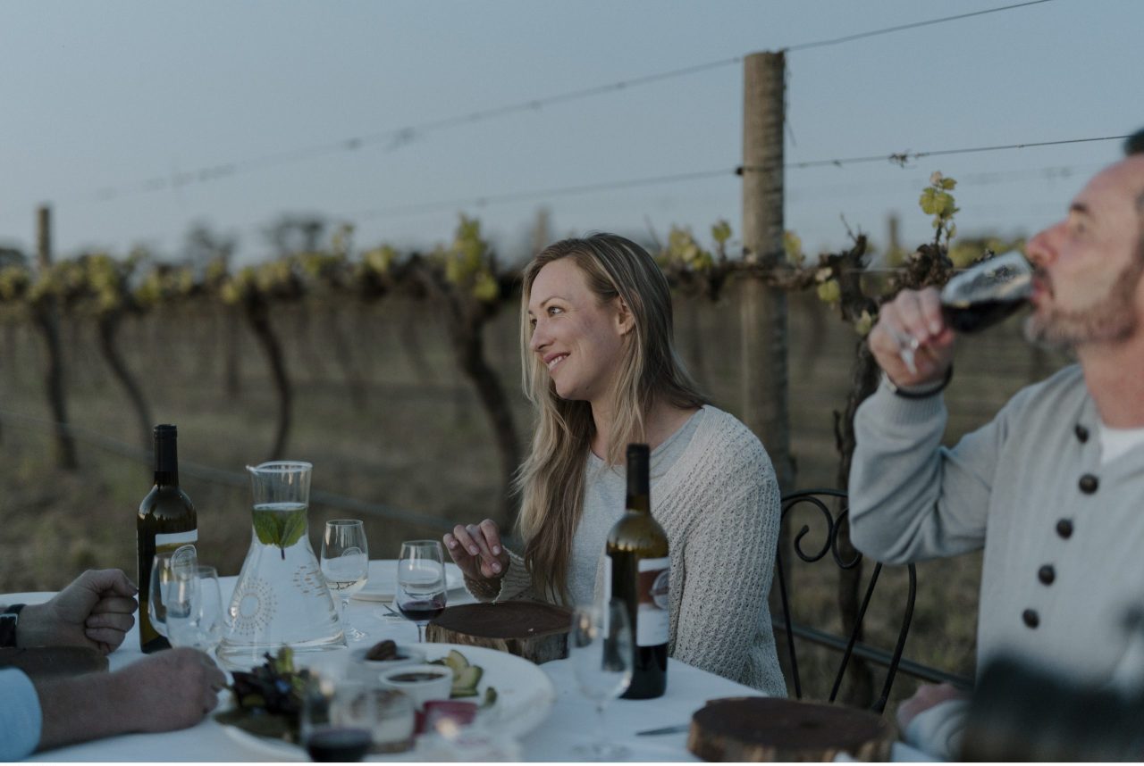 Couple enjoying food and drink outdoors in the vineyard at Restdown Wines, Barham.